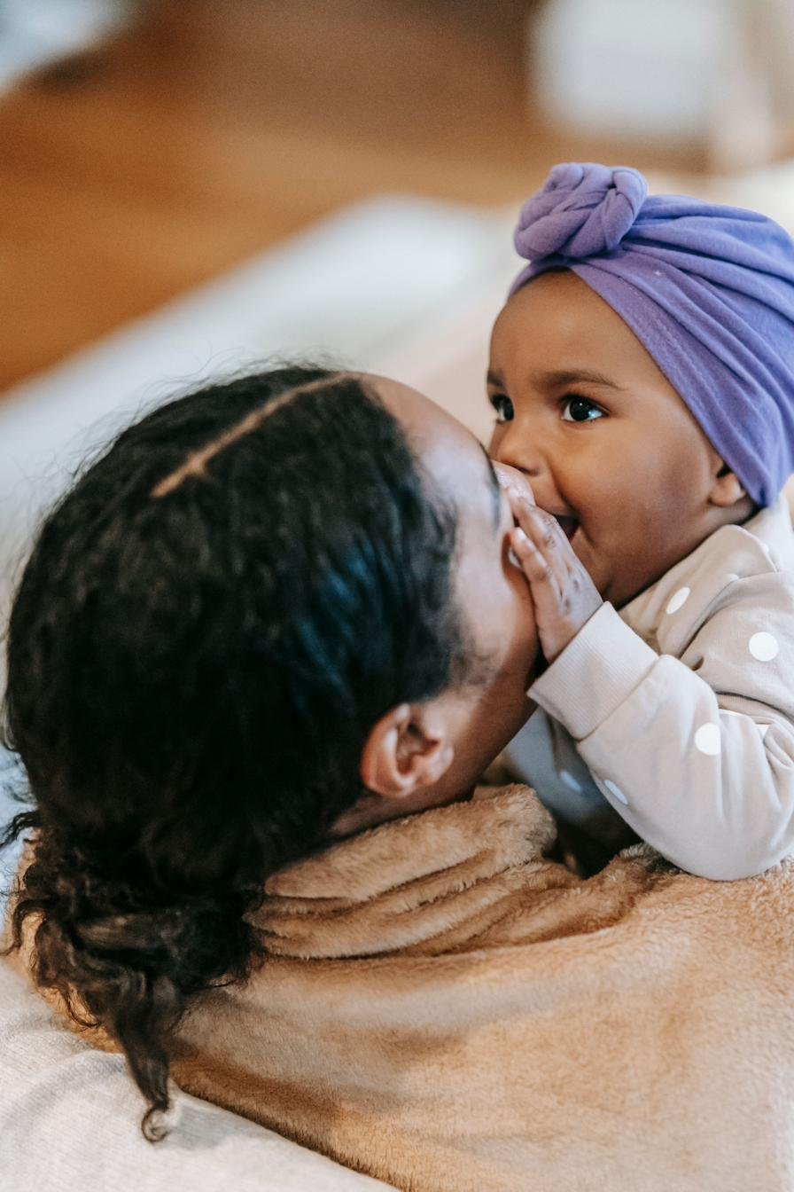 Parent and baby nose to nose, laughing together